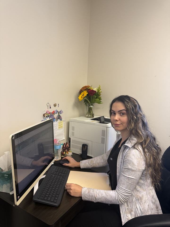 Front office staff member at the Ahad MD PC reception desk
